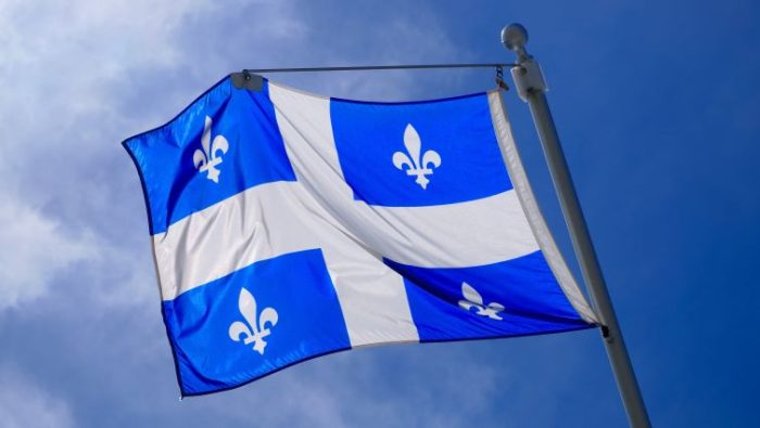 The Quebec flag on a sky background.