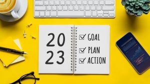 A day-planner on a bright desk that is used for 2023 goals and actionable plans.