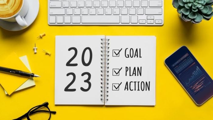A day-planner on a bright desk that is used for 2023 goals and actionable plans.