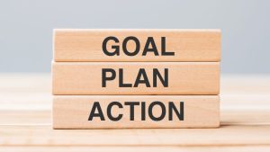 A stack of blocks that say GOAL, PLAN and ACTION.