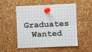 9 Things You Need to Know About Graduate Recruitment - A hiring sign that says graduates wanted.
