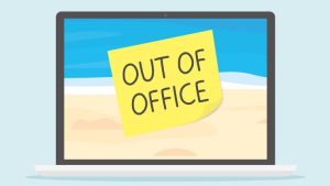 How To Write An Out-Of-Office Email - a lap with the image of a beach and post-it note that says "out of office" stuck on the screen.