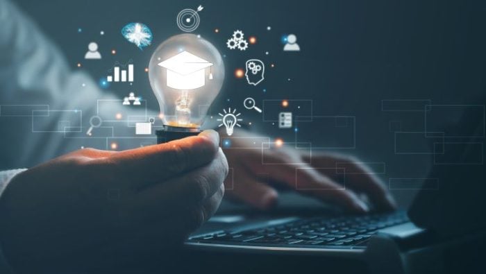 How To Launch A Digital Marketing Career For New Graduates - a professional person with the image of a graduation cap surrounding them typing on a laptop connect to clients around the world.