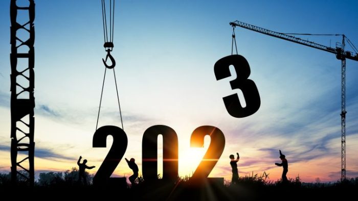 The 2023 Construction Holidays" Everything You Need To Know - giant numbers of 2023 being put in place by a crane and construction crew against a blue and white sky.