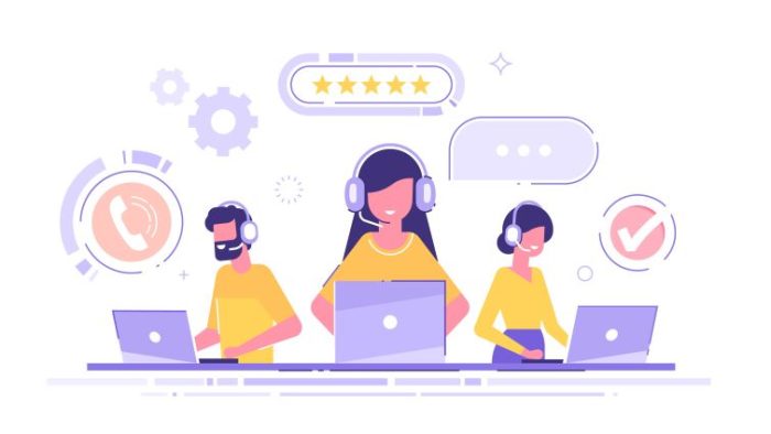 How to Create a Better Call Center Environment for Your Agents - a group of call center employees working and looking happy.