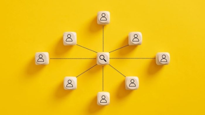 6 Steps Every Business Should Follow for Full-Cycle Recruiting - a series of icons representing job applicants forming a circle, with a magnifying glass representing recruitment.