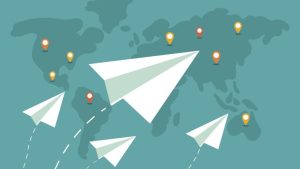How To Write A Resume As Newcomer to Canada - paper planes made of resumes fly over a map of the world.