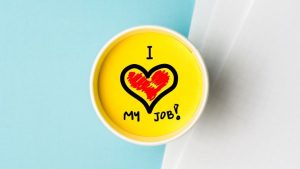 Finding Purpose-Driven Work How to Align Your Career with Your Passions - a sign on a desk that says I heart my job.